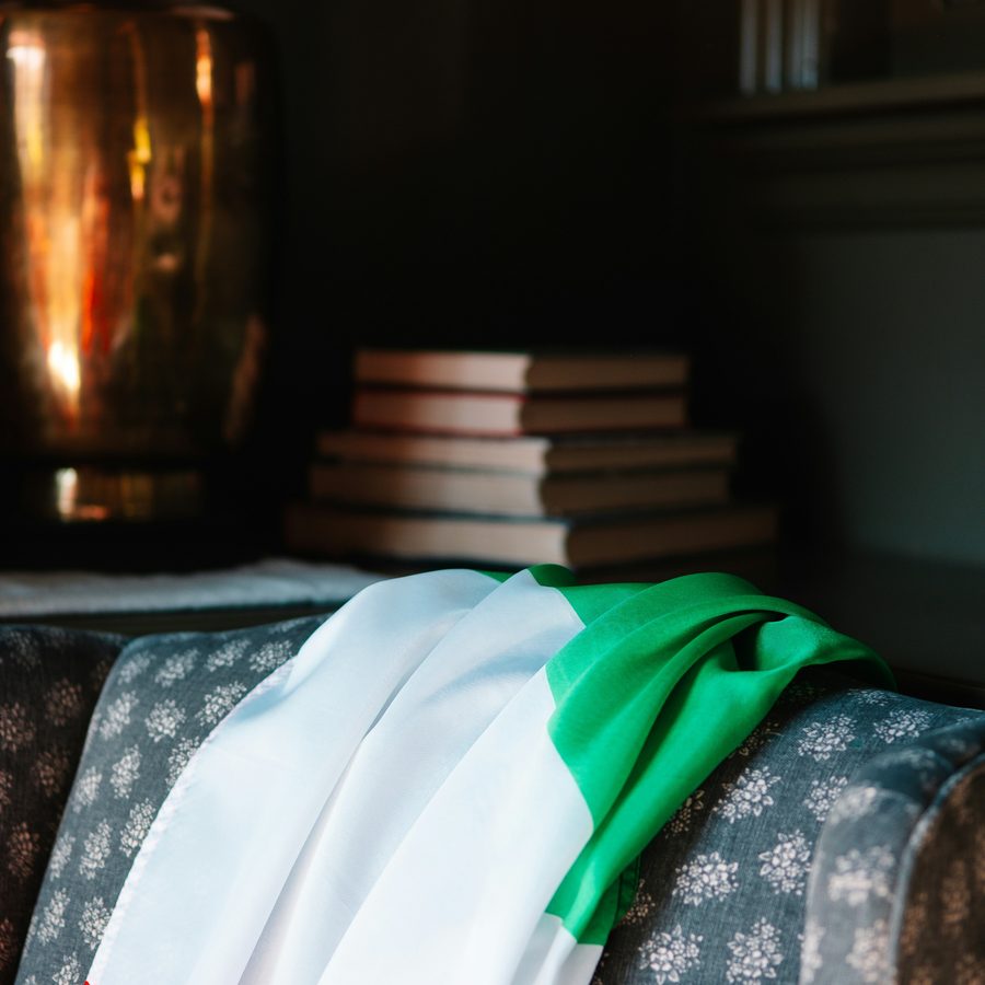 An Italian flag folded over a stack of old books