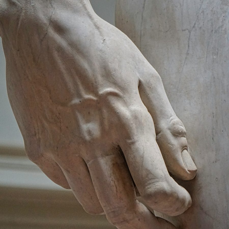 The hand of a marble statue, carved in detail